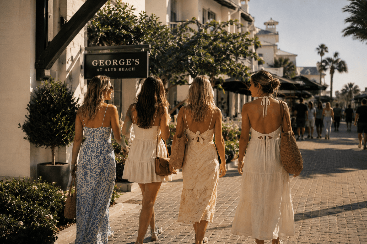 Four women walking through a sunny coastal town toward brunch on a late-summer morning.
