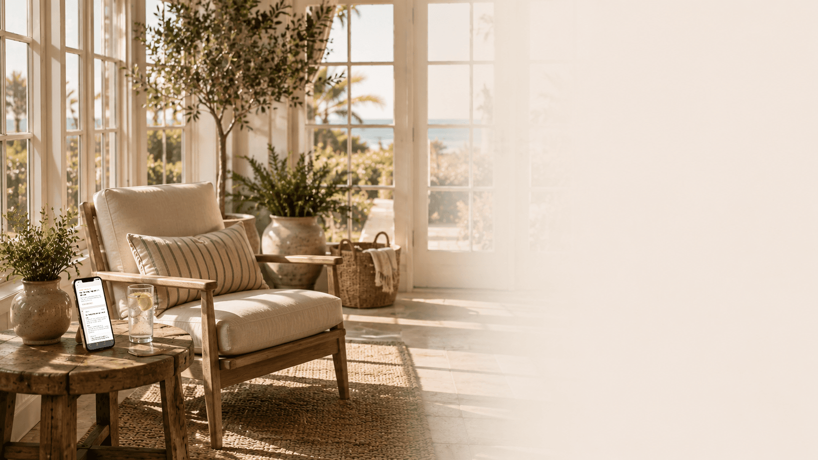 A peaceful coastal sunroom with the Nova sobriety recovery timeline displayed on a phone.